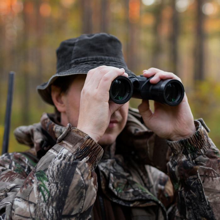 Hunter holding binoculars in the outdoor
