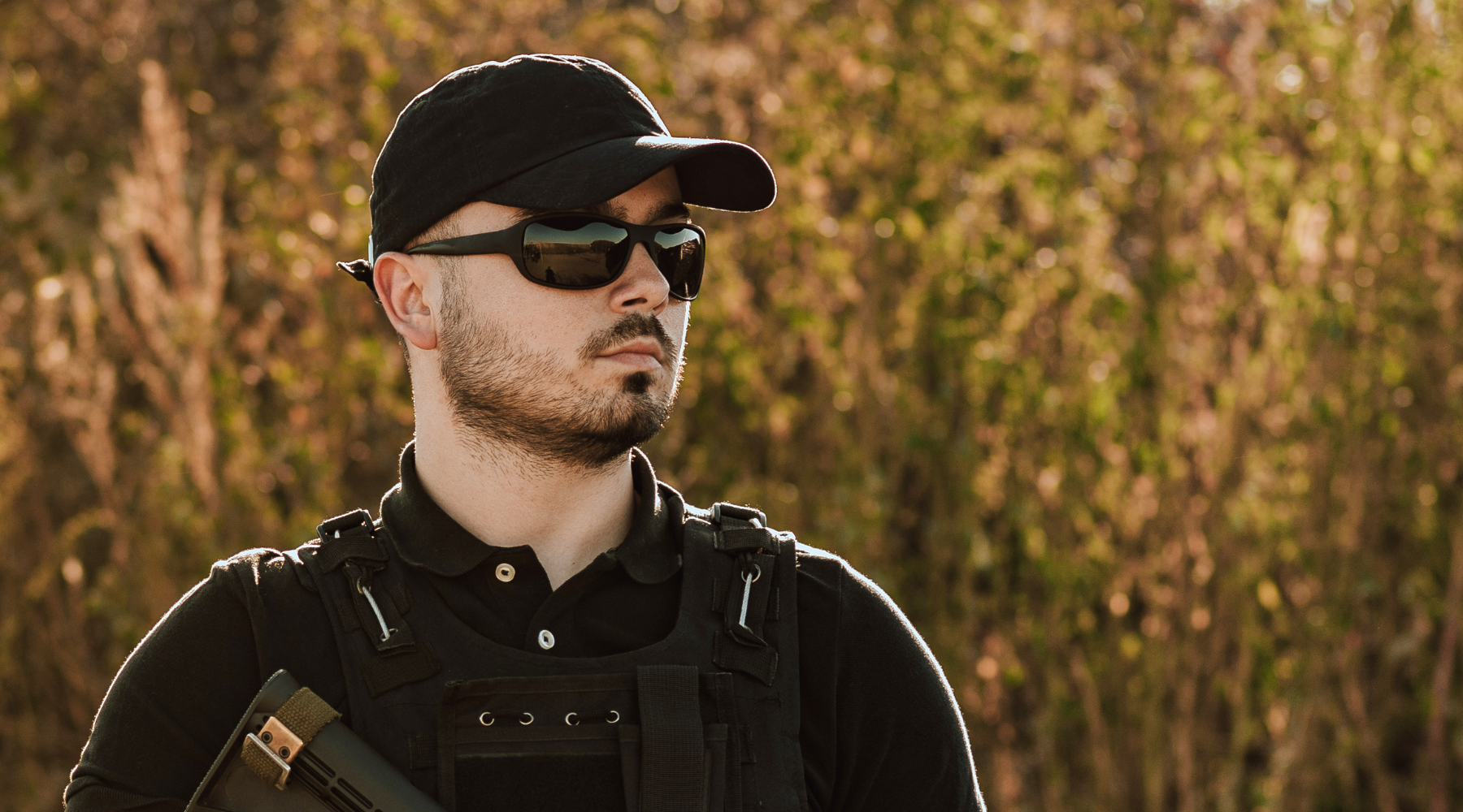 Man with Ballistic Eye Protection and Black Hat